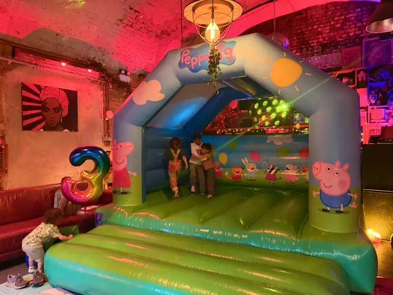 Kids' birthday party at Love Shack with Peppa Pig bouncy castle in The Bunker