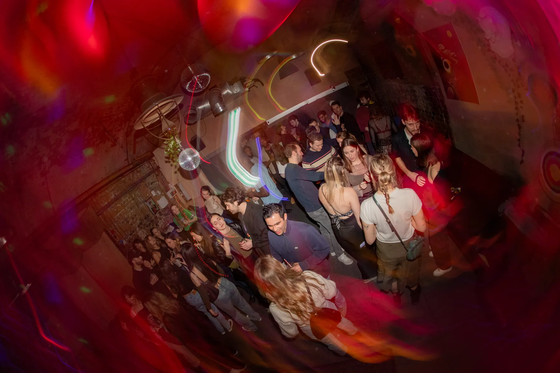 A late-night crowd dancing under disco lights at Love Shack